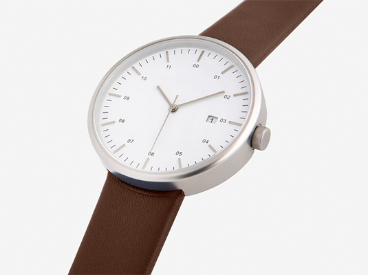 a modern watch with brown watch band and light sliver border of the watch and white background 