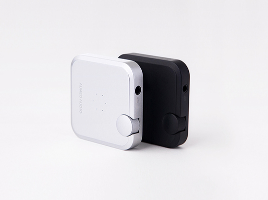 two sets of airpods one in a black color and the other one in a white color with small hole in each one where it is the socket to charge your airpods